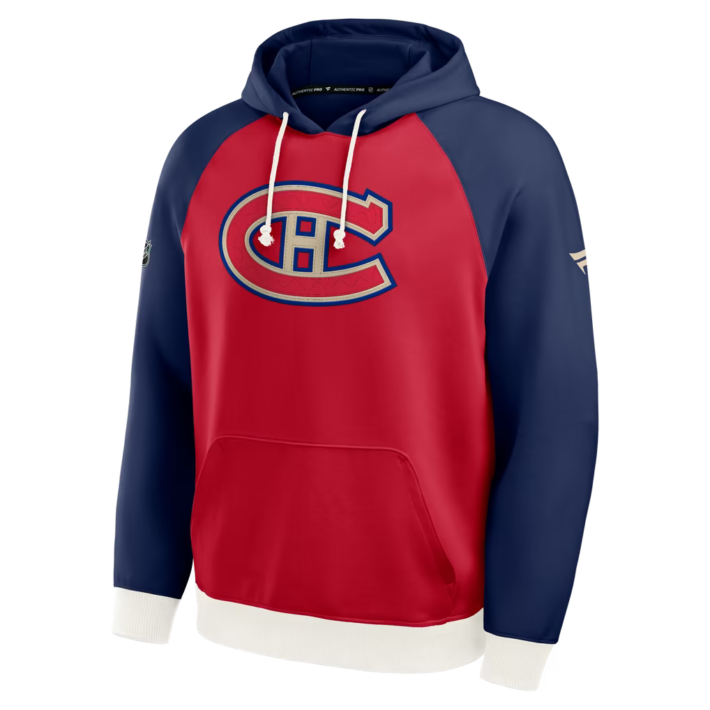 A Montreal Canadiens pullover hoodie with a red body, navy blue raglan sleeves, and a large embroidered team logo on the chest, shown on a clean white background.